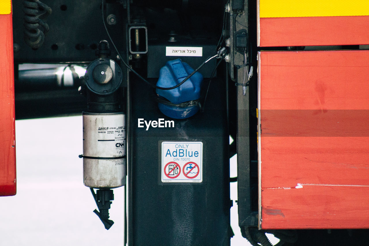 CLOSE-UP OF INFORMATION SIGN ON RED BUS