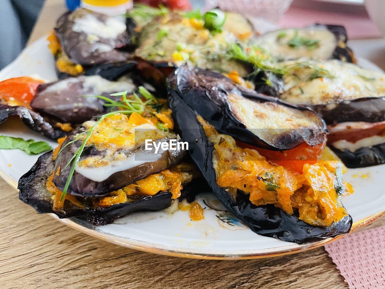 High angle view of baked eggplant with cheese in plate on table