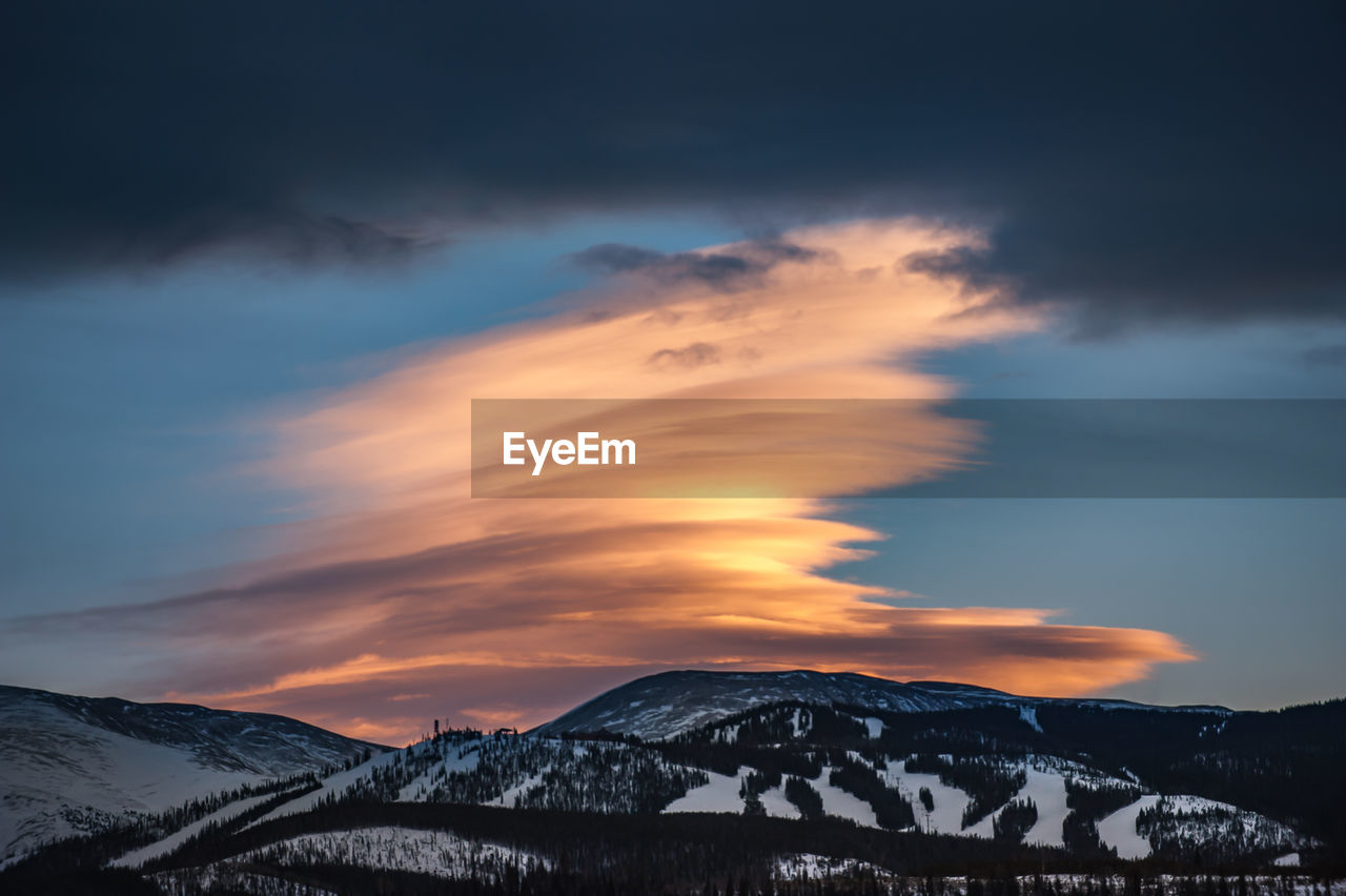 A massive orange cloud towers above winter park ski resort in colorado