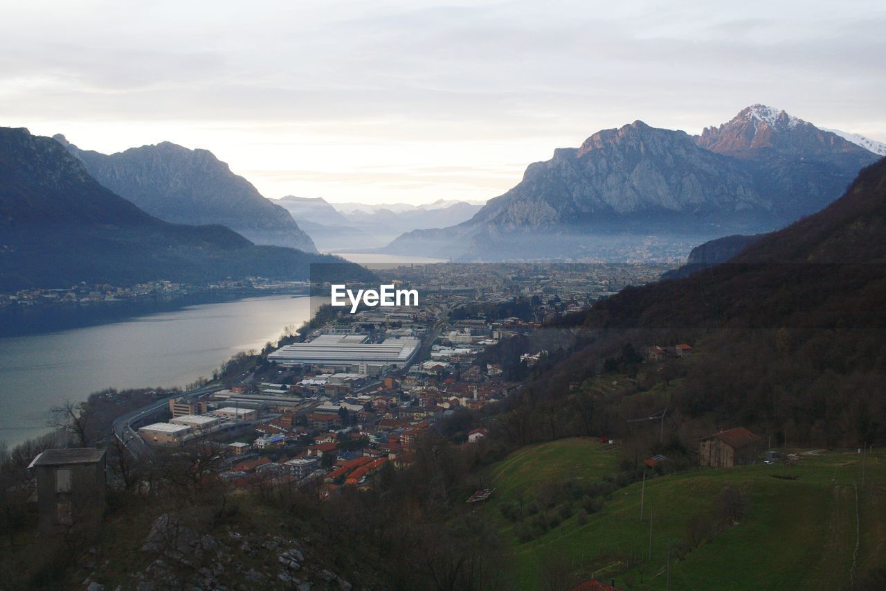 High angle view of townscape by mountain against sky