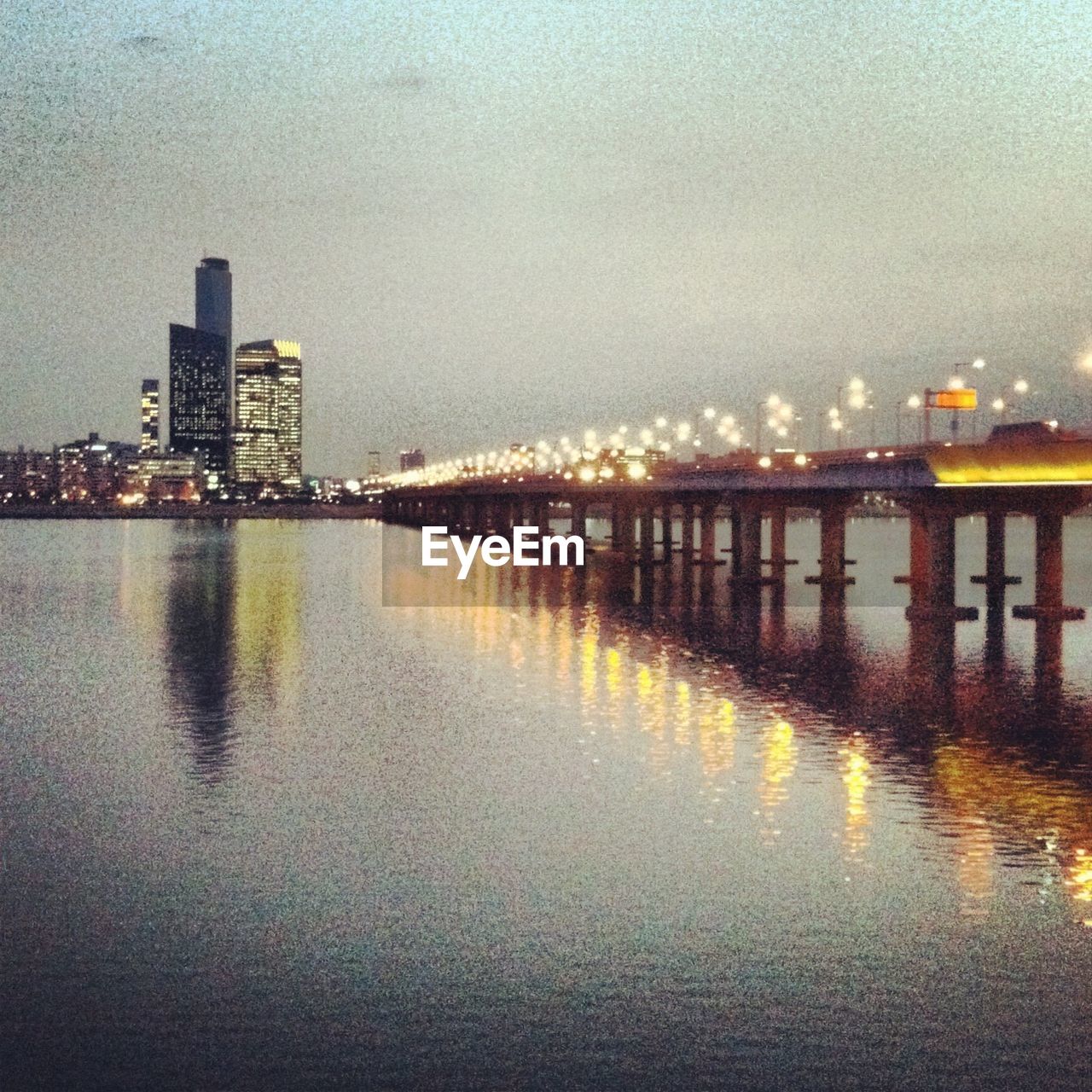 VIEW OF ILLUMINATED CITYSCAPE AT NIGHT