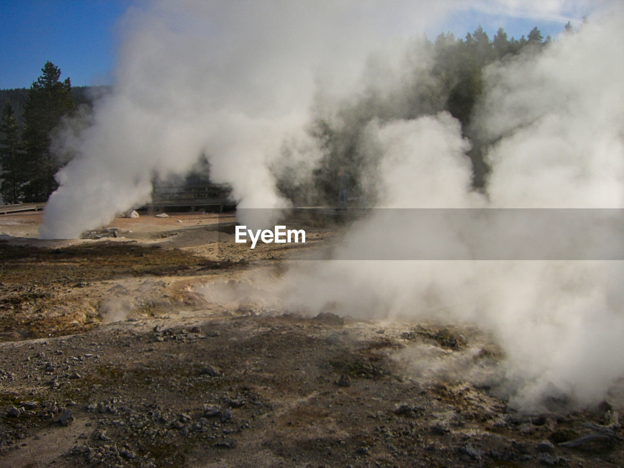 Smoke emitting from volcanic mountain against sky