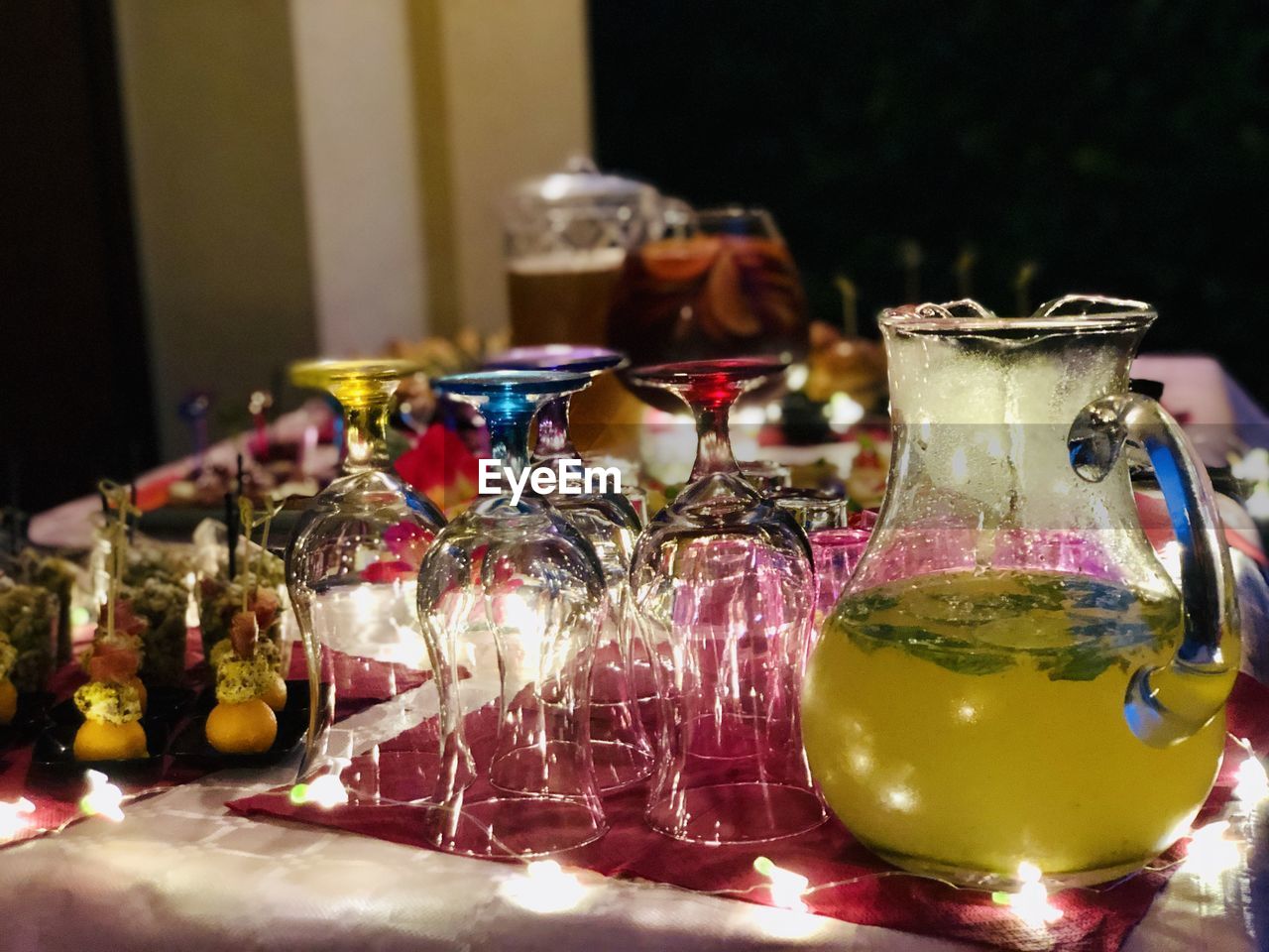 Close-up of drink in glass jar on table with appetizer and food