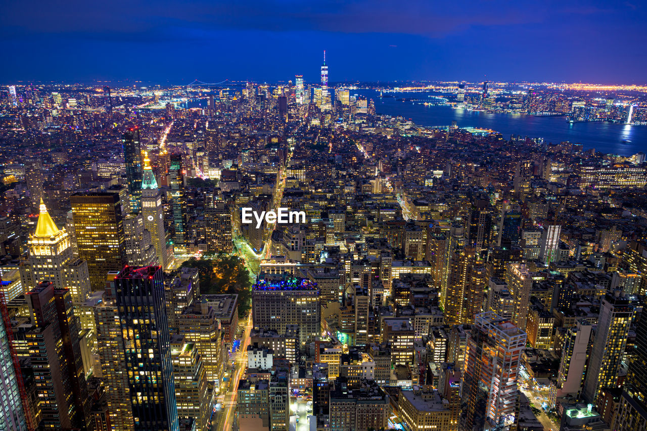 High angle view of illuminated city buildings at night