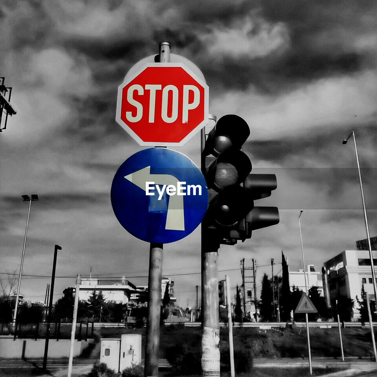 ROAD SIGN AGAINST CLOUDY SKY