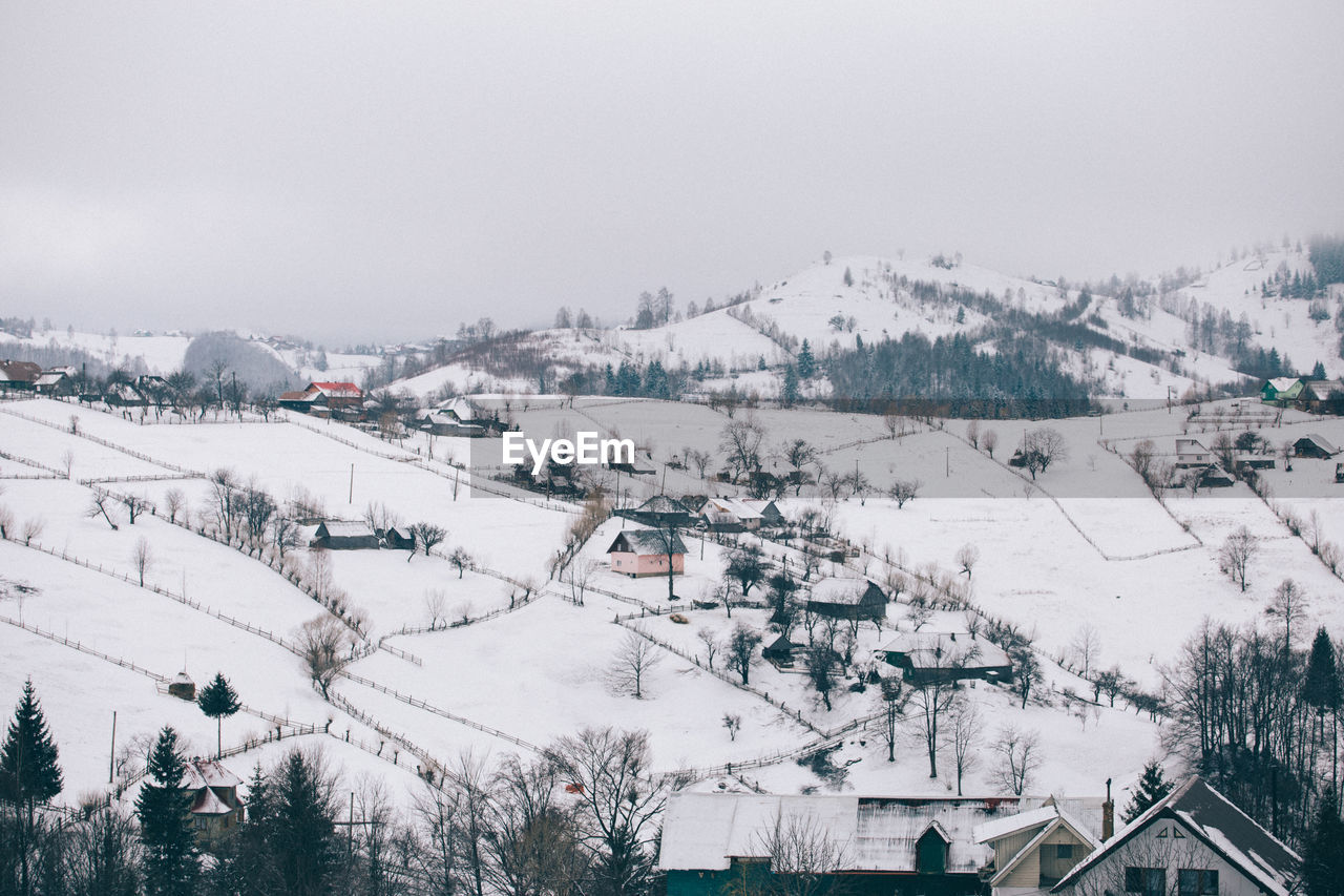 Panoramic view of snow covered landscape against sky