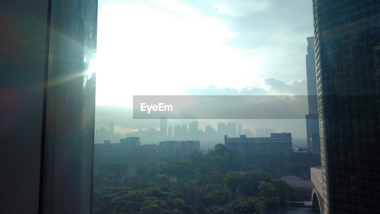 VIEW OF CITYSCAPE THROUGH WINDOW