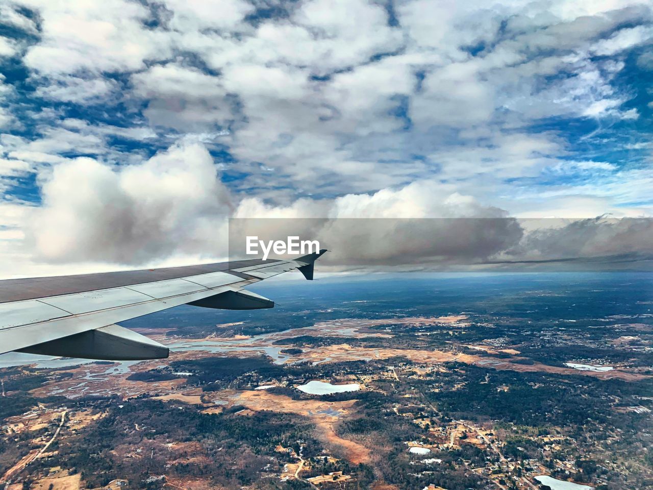 AIRPLANE FLYING OVER CLOUDS