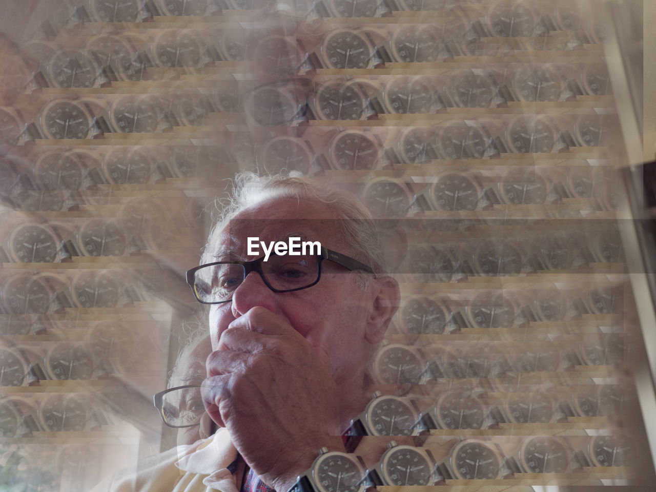 Double exposure of senior man and wristwatch