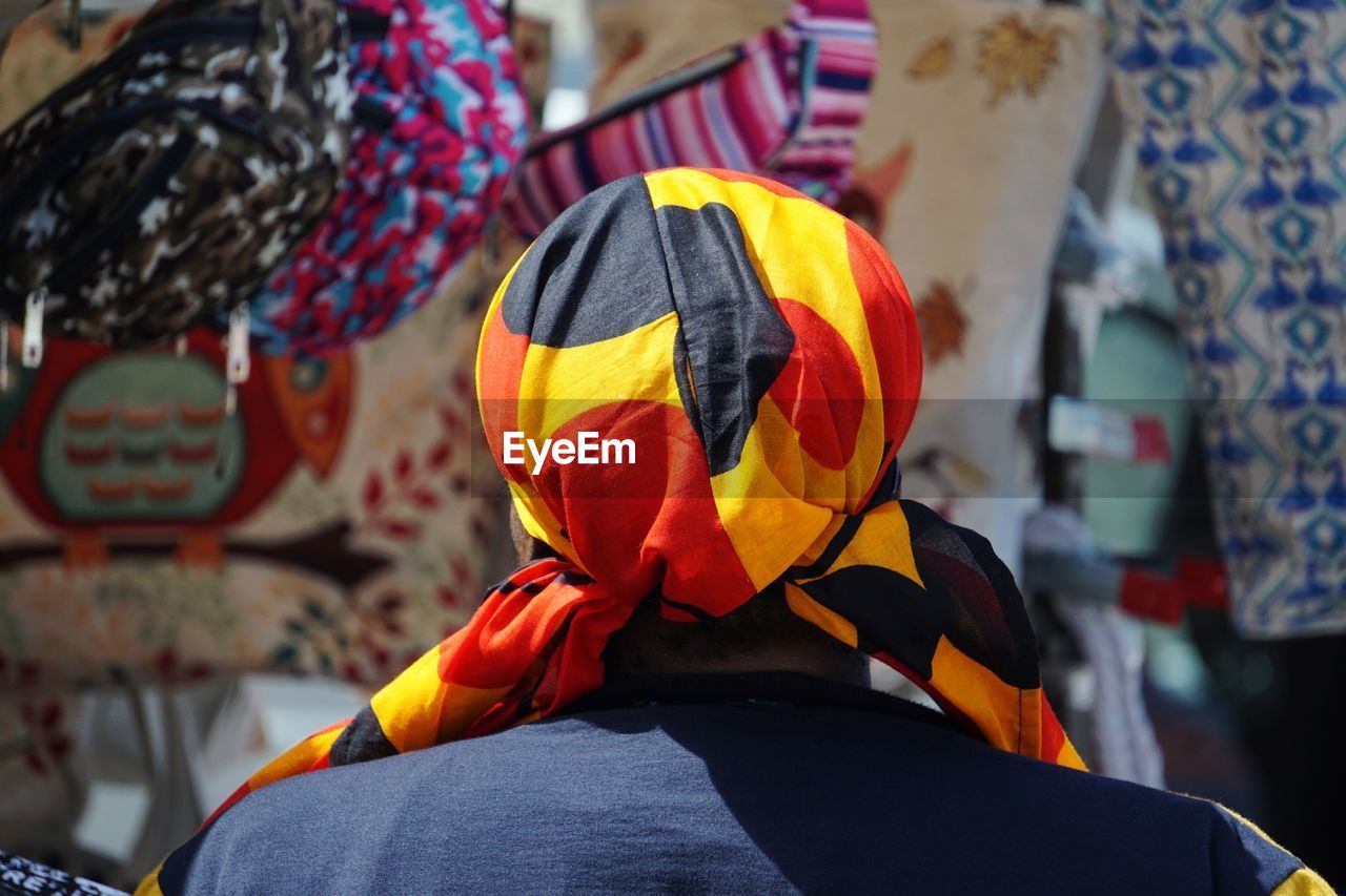 Rear view of man wearing colorful scarf