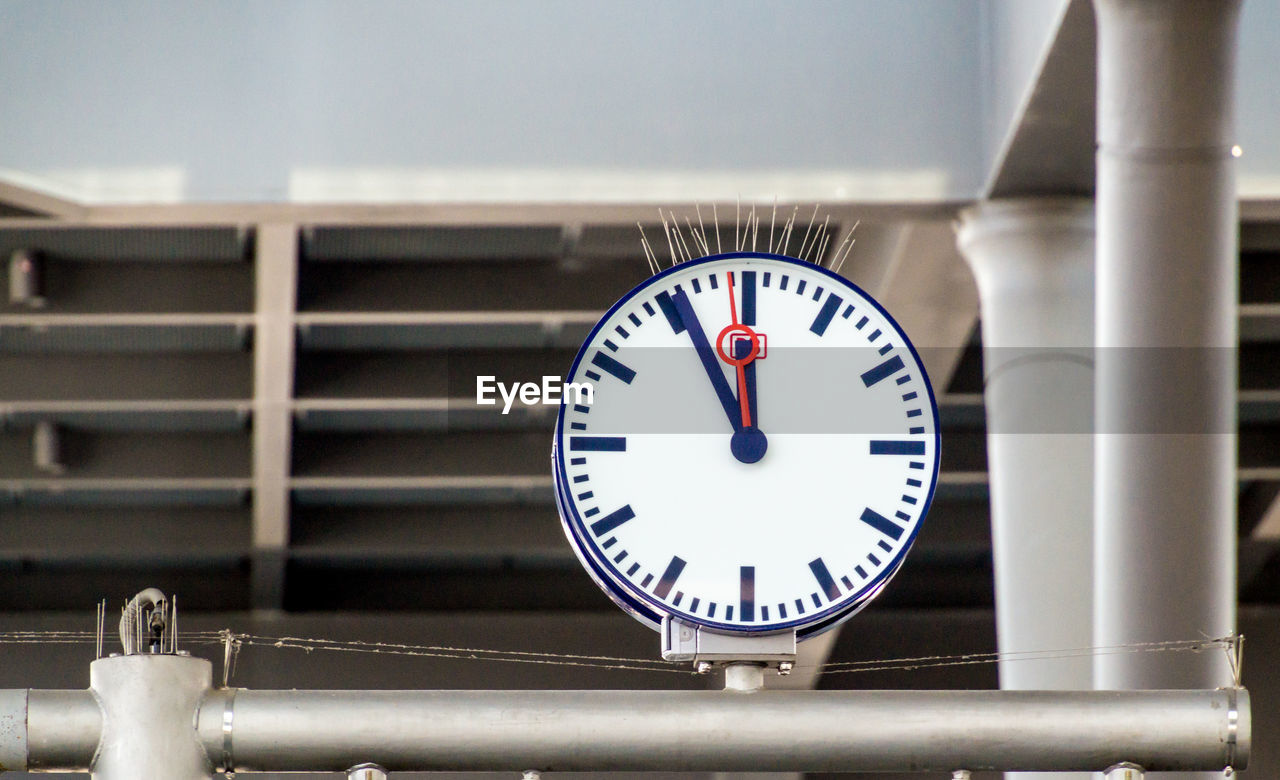 Low angle view of clock on metal