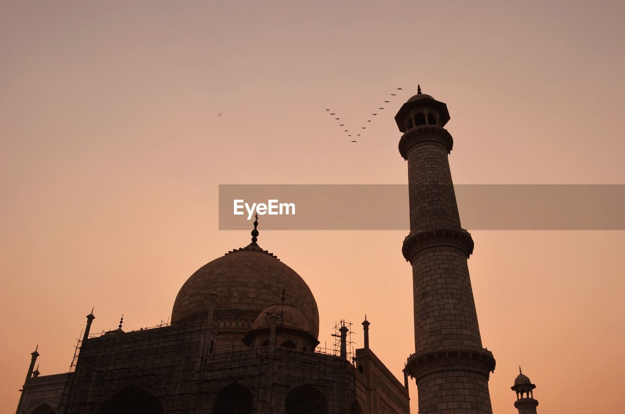 Low angle view of taj mahal against sky during sunset