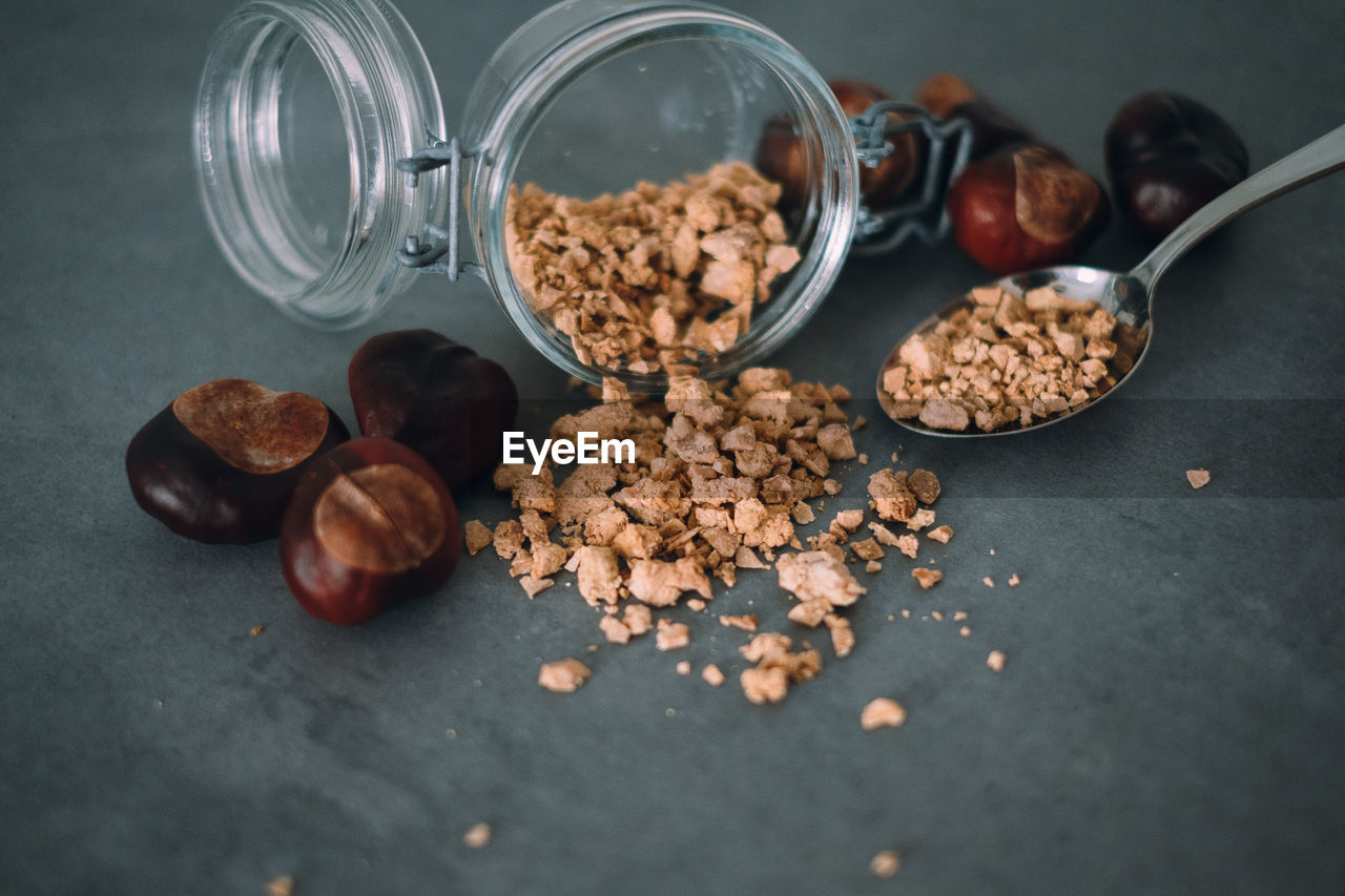 Chestnuts and container on table