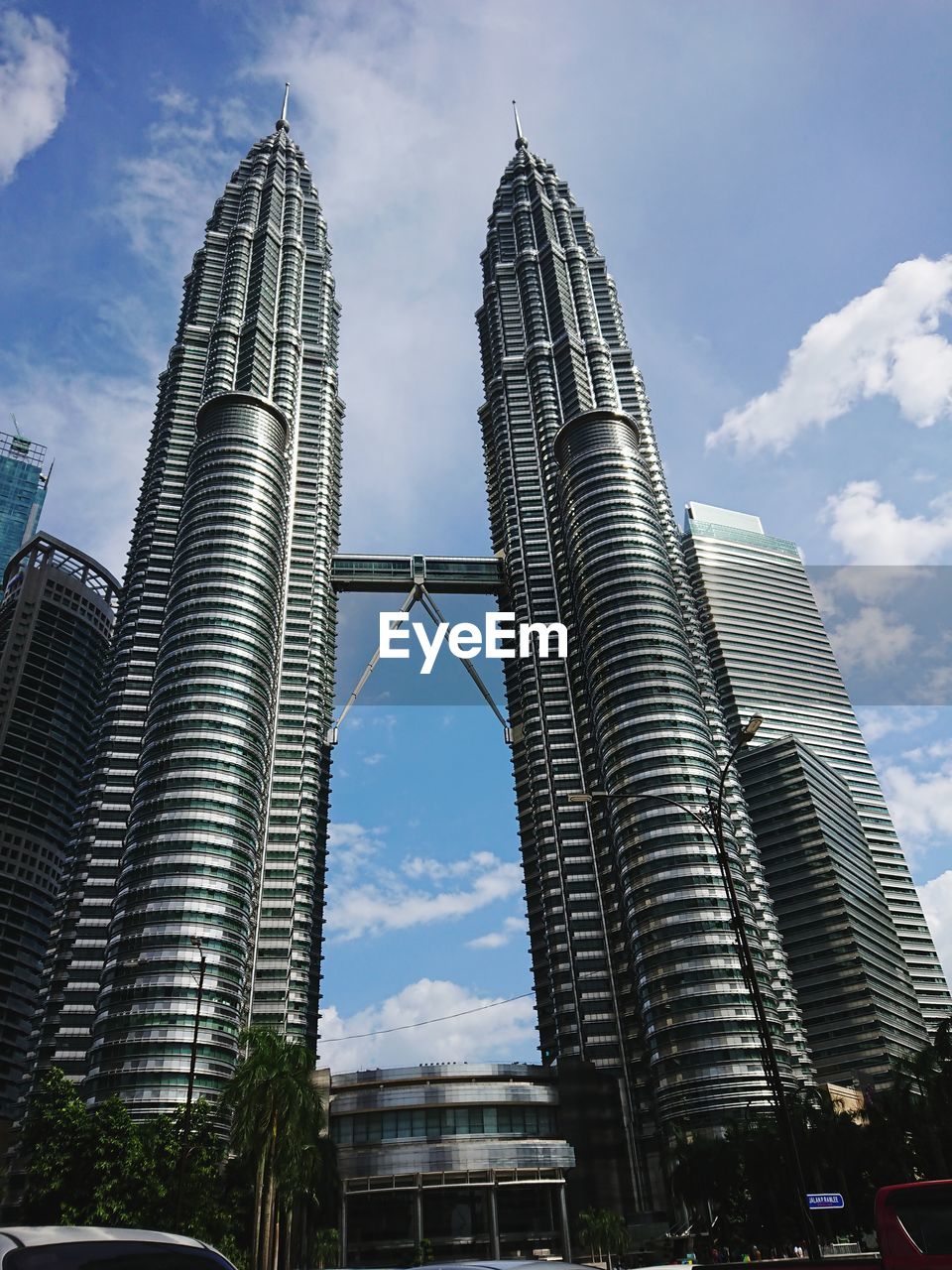 Low angle view of skyscrapers against cloudy sky