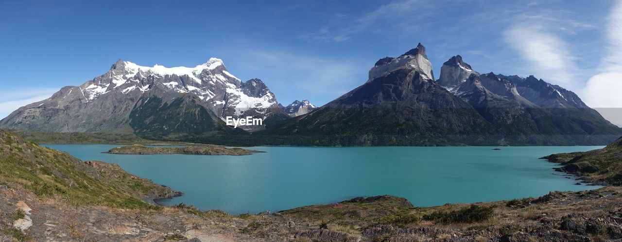 scenic view of lake and mountains against blue sky