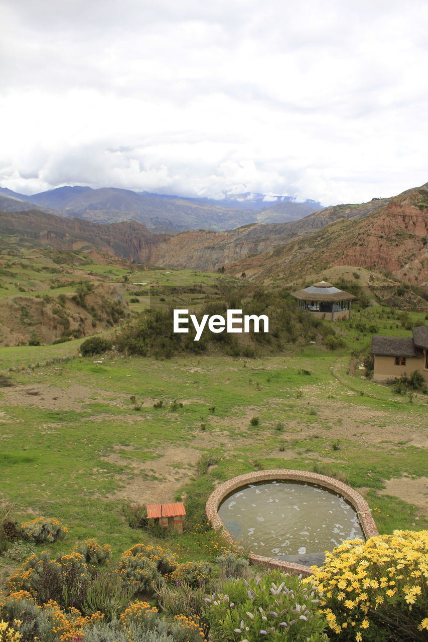 Scenic view of mountains against cloudy sky