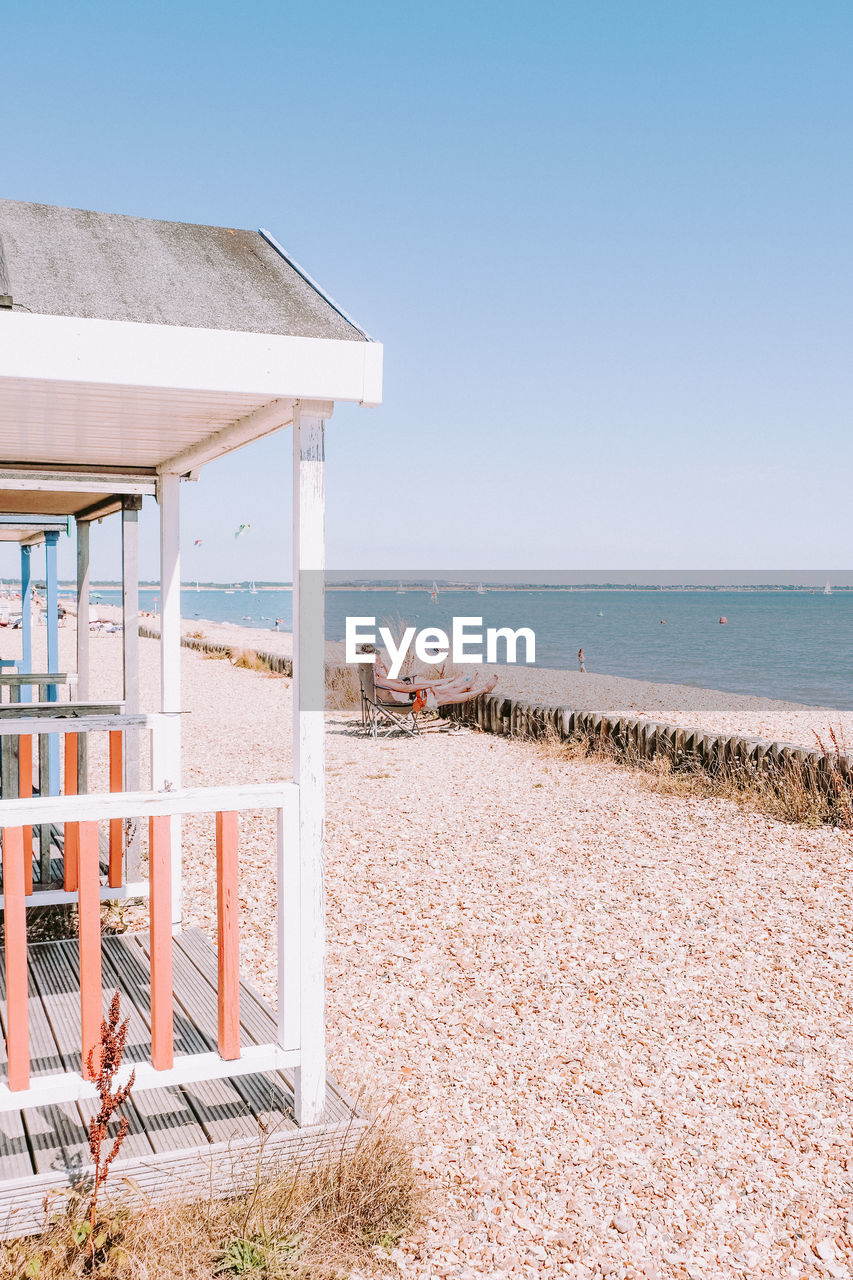 Beach huts against clear sky