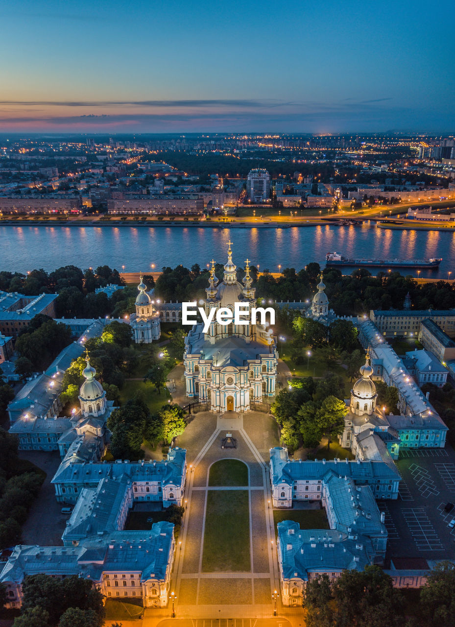 Aerial view of illuminated cityscape against sky