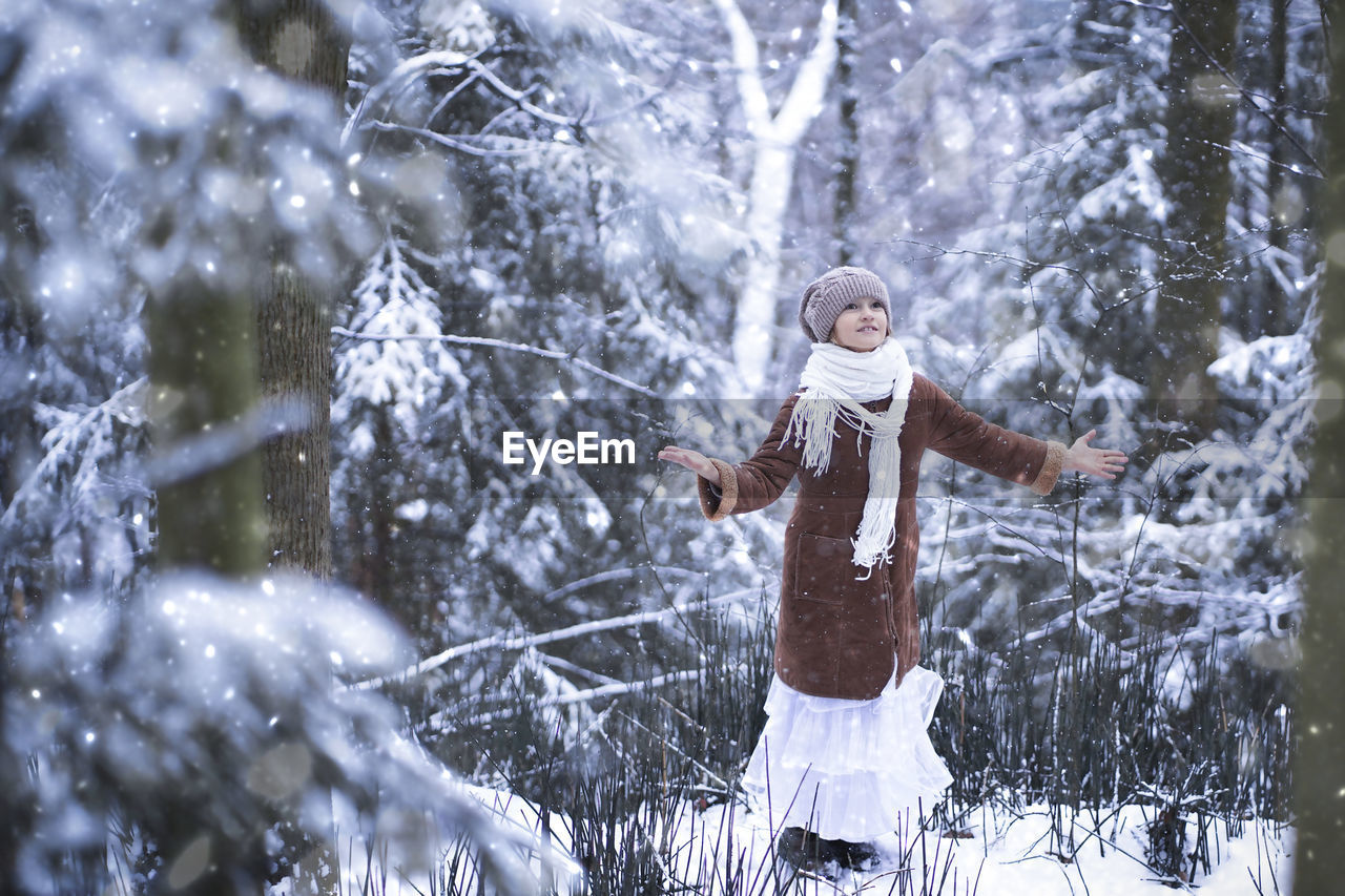 Cute girl standing outdoors during winter