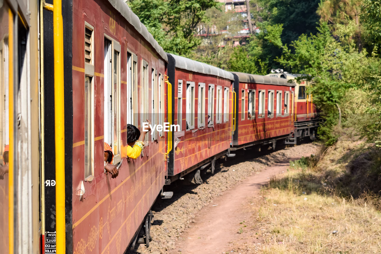 Kalka shimla toy train moving on mountain slopes, beautiful view, one side mountain, one side valley