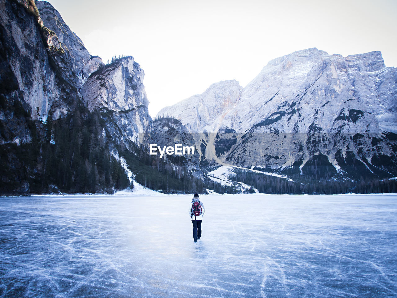 PERSON ON SNOW COVERED MOUNTAIN AGAINST SKY