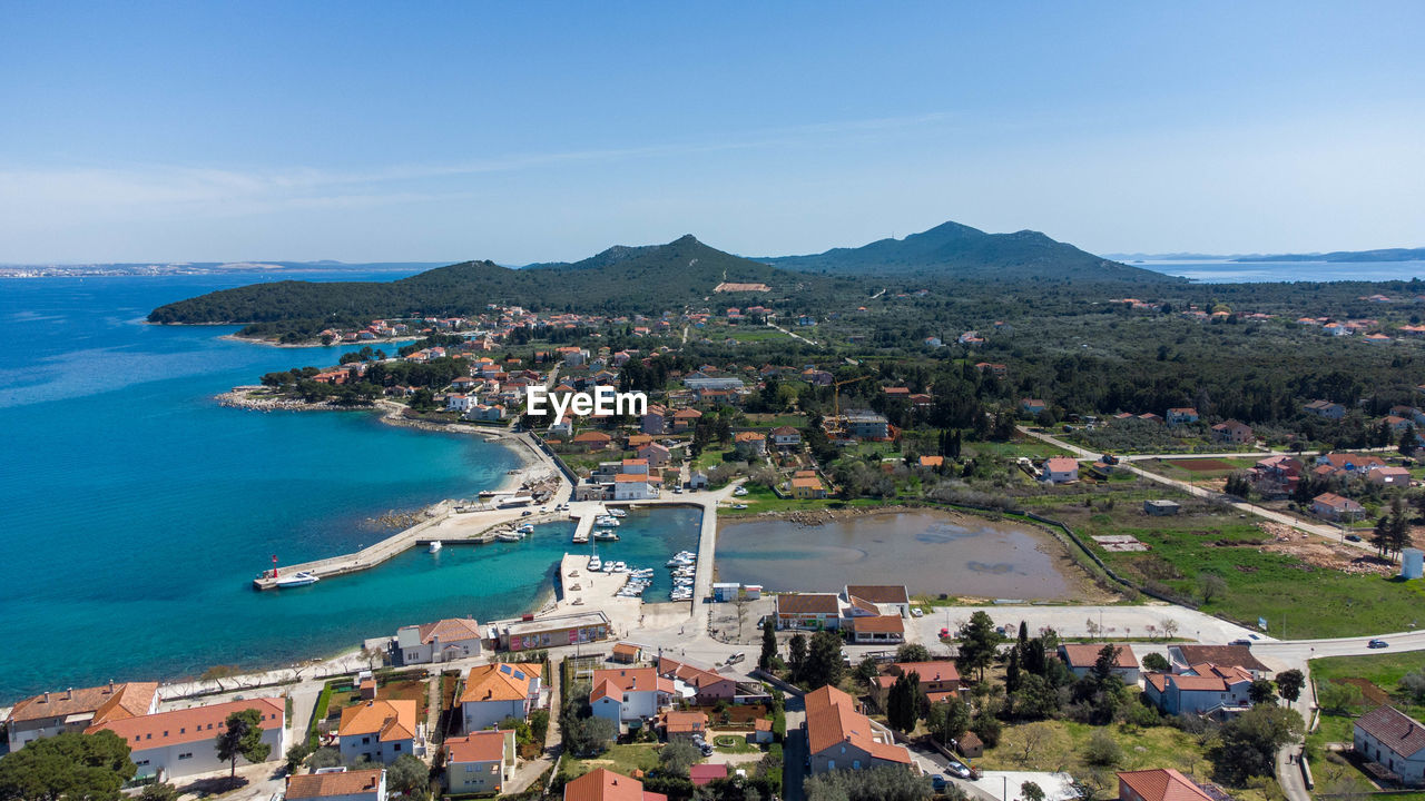 high angle view of townscape by mountains against sky