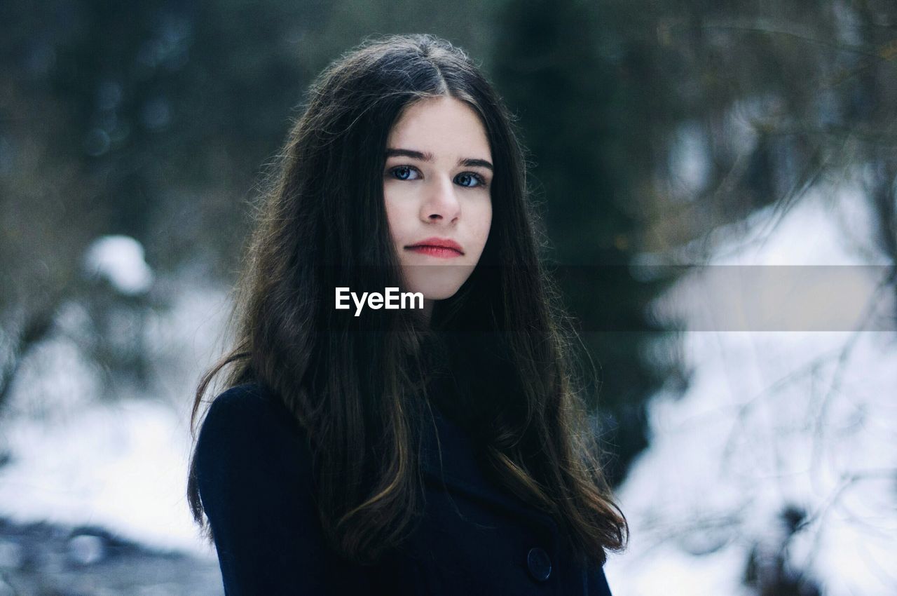 Portrait of young woman standing outdoors