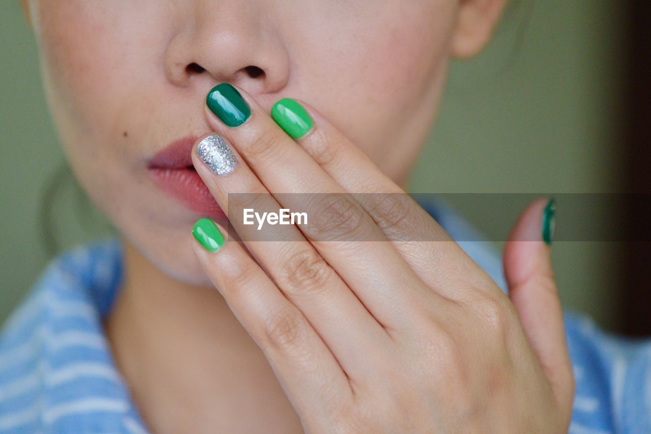 Close-up of woman with colorful nails