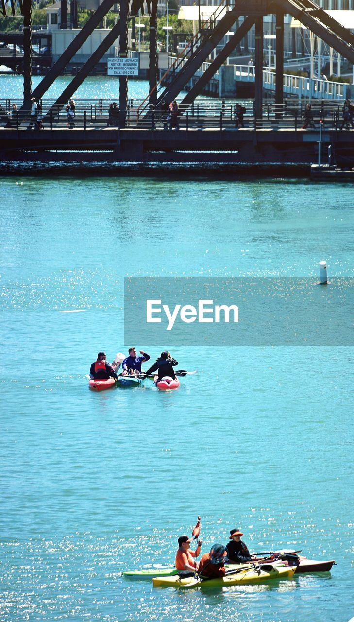 PEOPLE SAILING ON BOAT IN RIVER