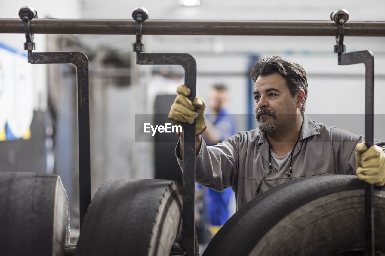 Tire repairer adjusting hooks on tires