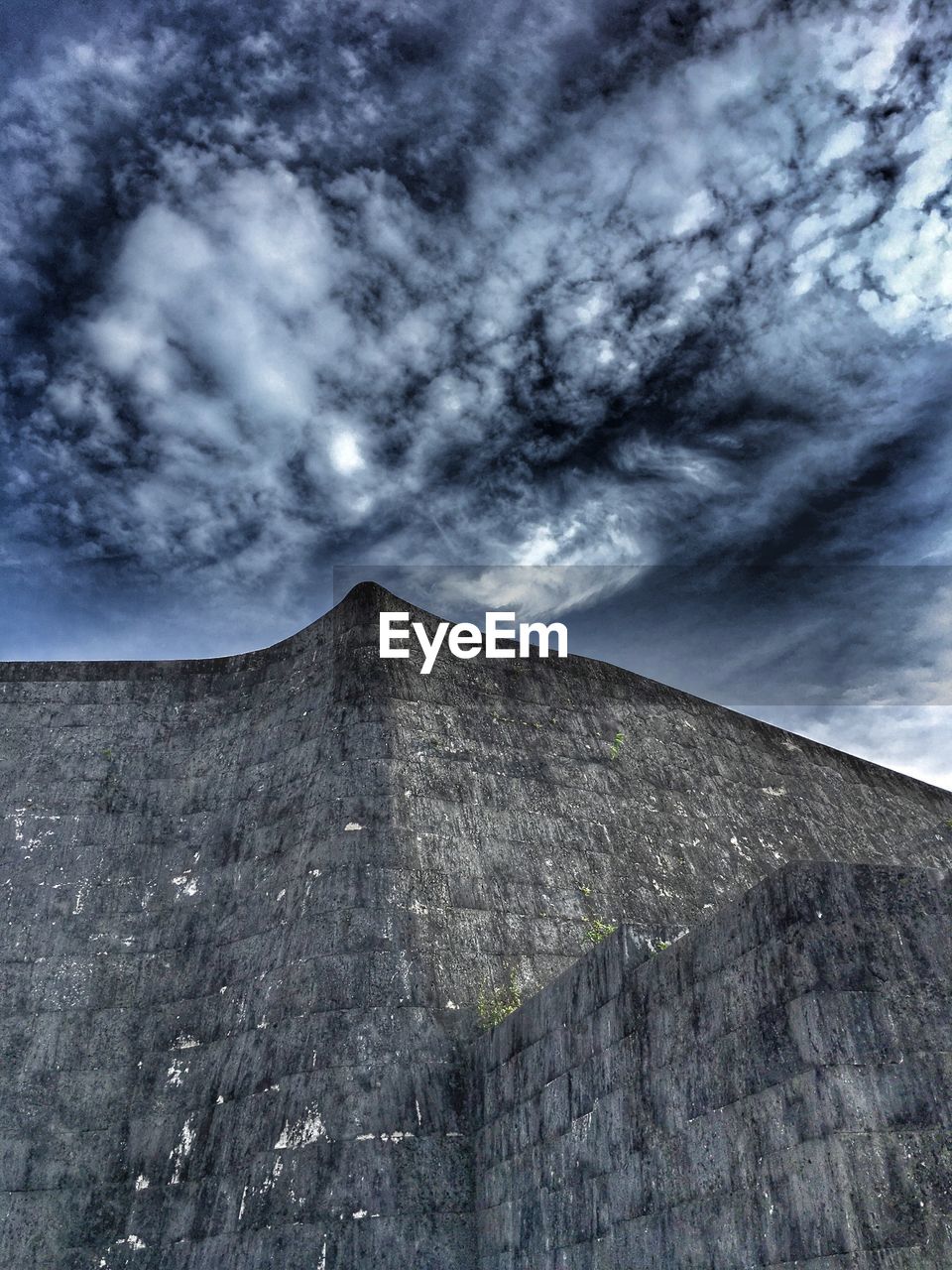 LOW ANGLE VIEW OF CLOUDY SKY OVER MOUNTAINS