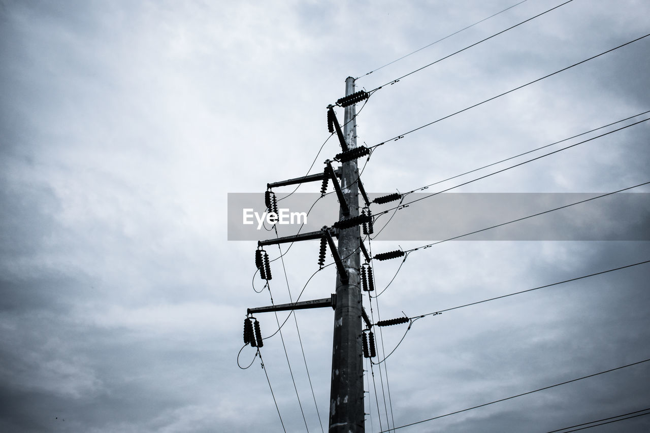 Low angle view of telephone pole against sky