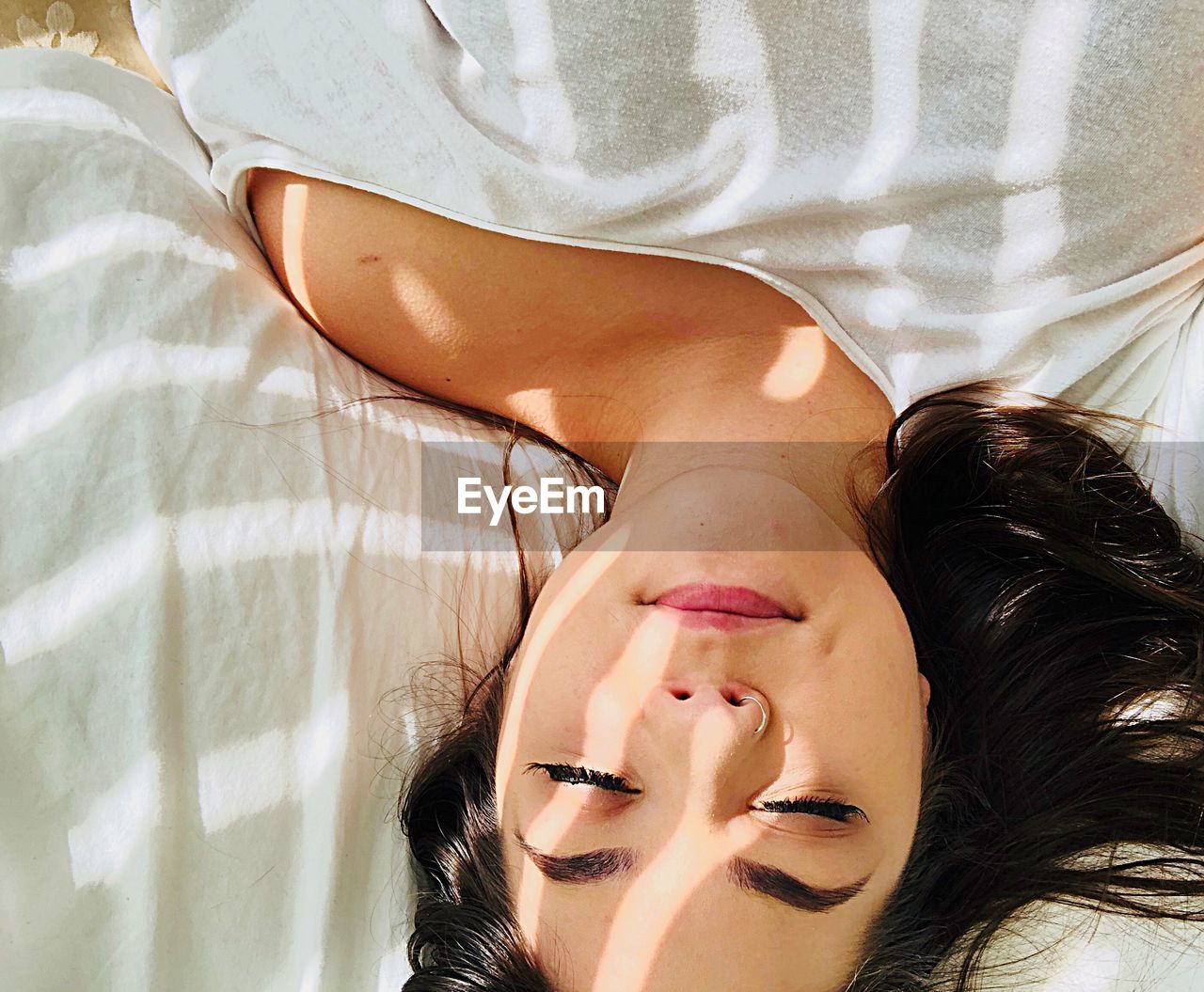 Directly above shot of young woman sleeping on bed