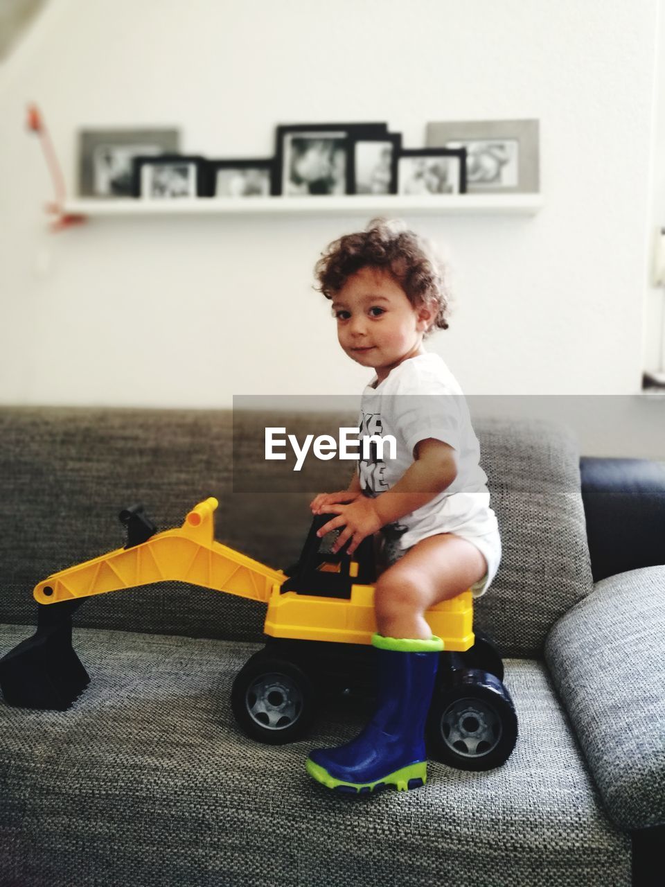 PORTRAIT OF CUTE BOY PLAYING WITH TOY CAR