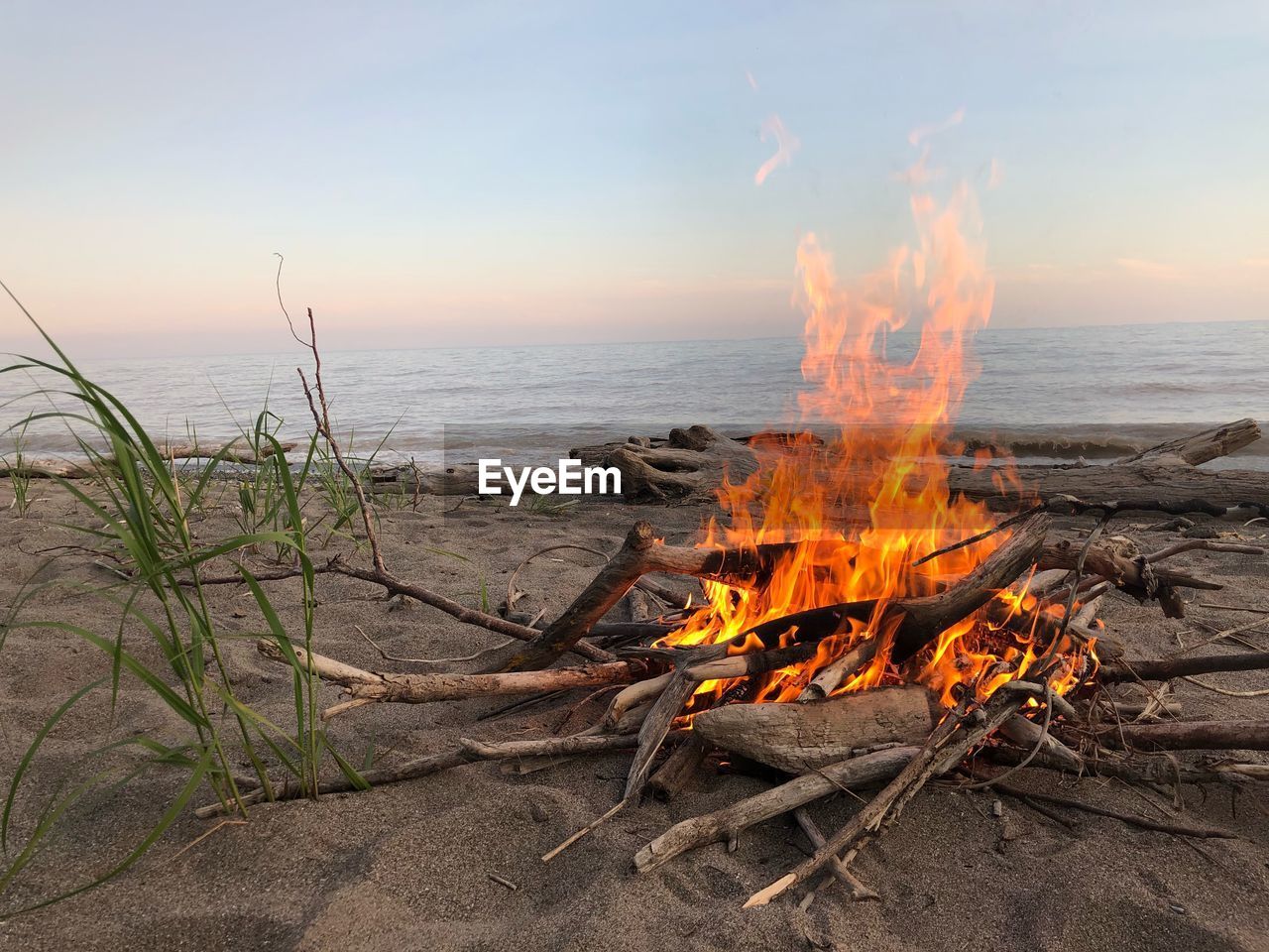 PANORAMIC VIEW OF BONFIRE ON BEACH