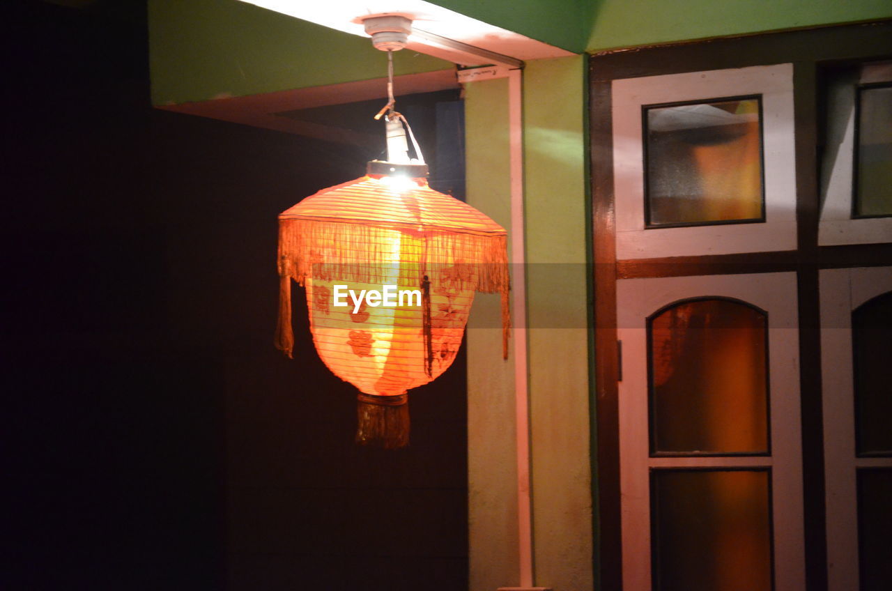 Low angle view of illuminated lantern at home
