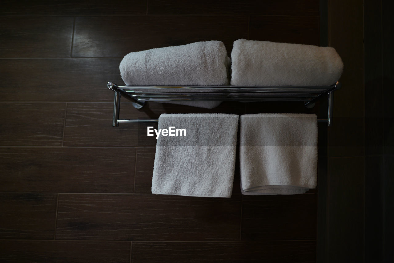 Close-up of towels and napkin on shelf in bathroom