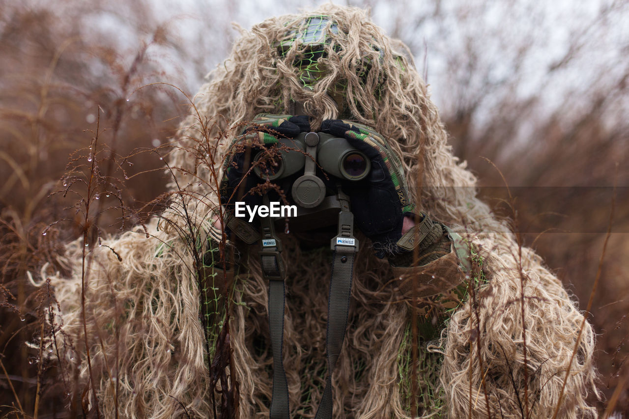 Kikimora soldier with binoculars in his hands