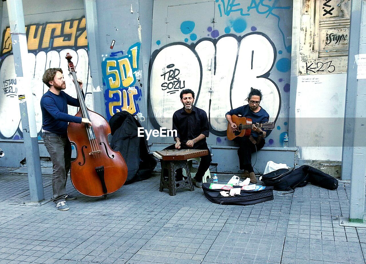 YOUNG MEN SITTING ON GUITAR