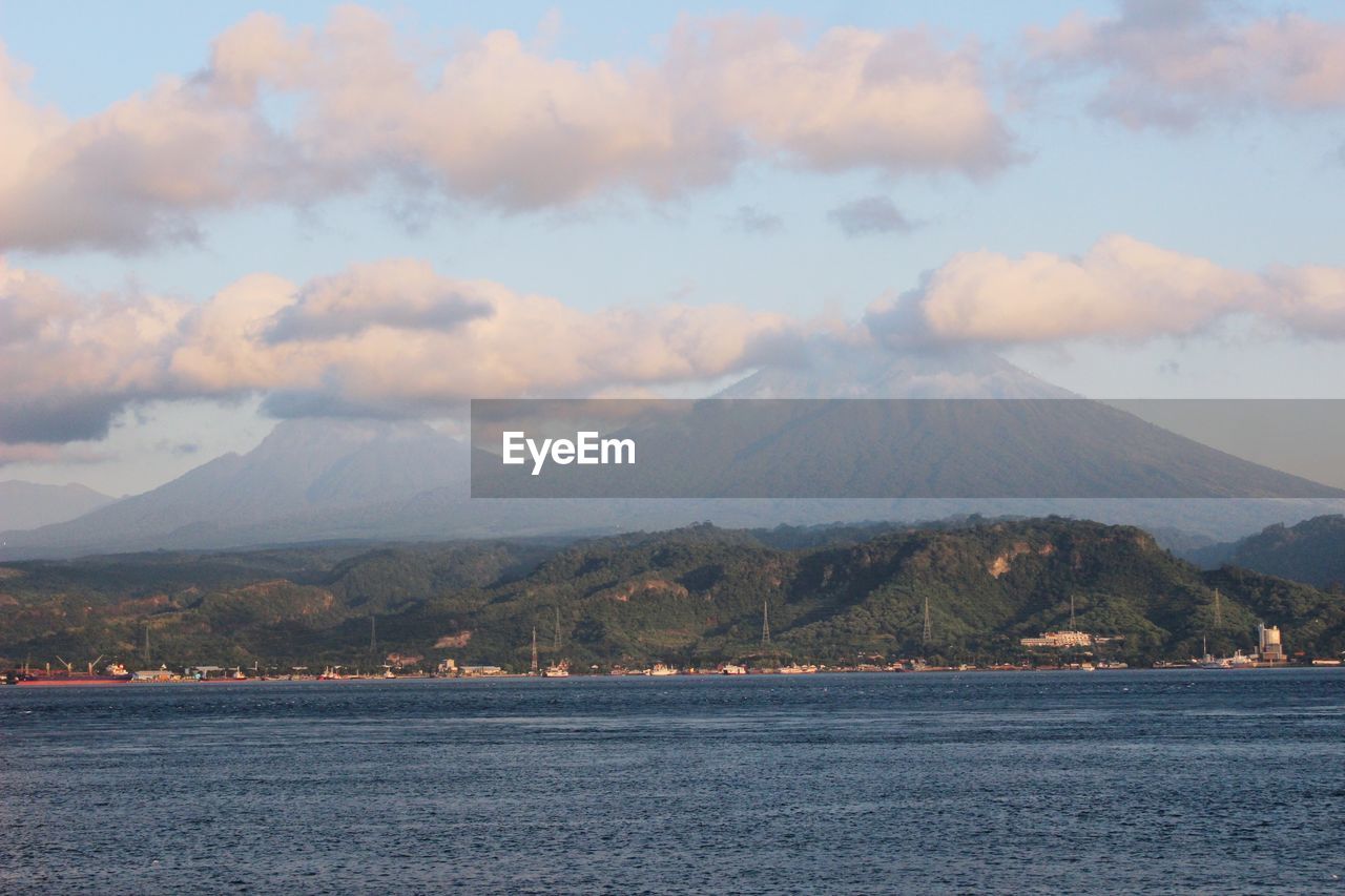 Scenic view of sea and mountains against sky