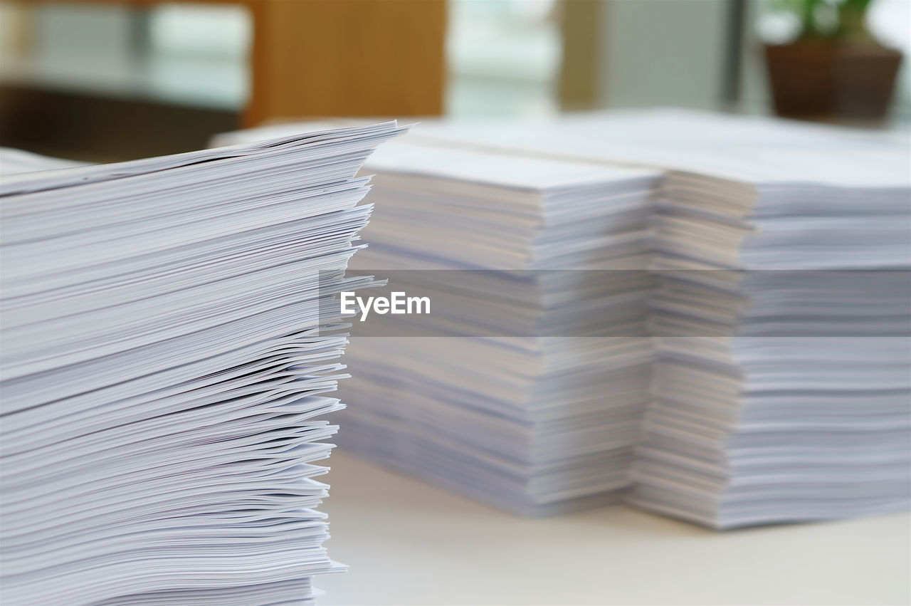 CLOSE-UP OF STACK OF WHITE TABLE