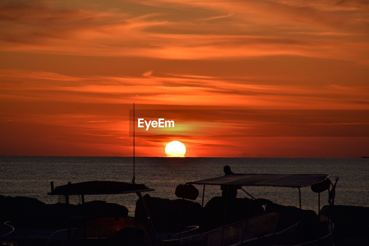 Scenic view of sea against orange sky