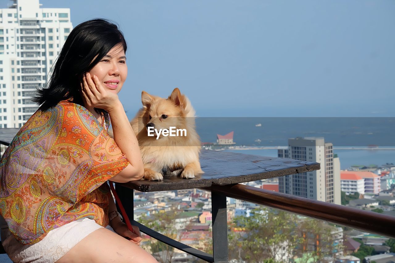 Woman sitting watching the view with a dog