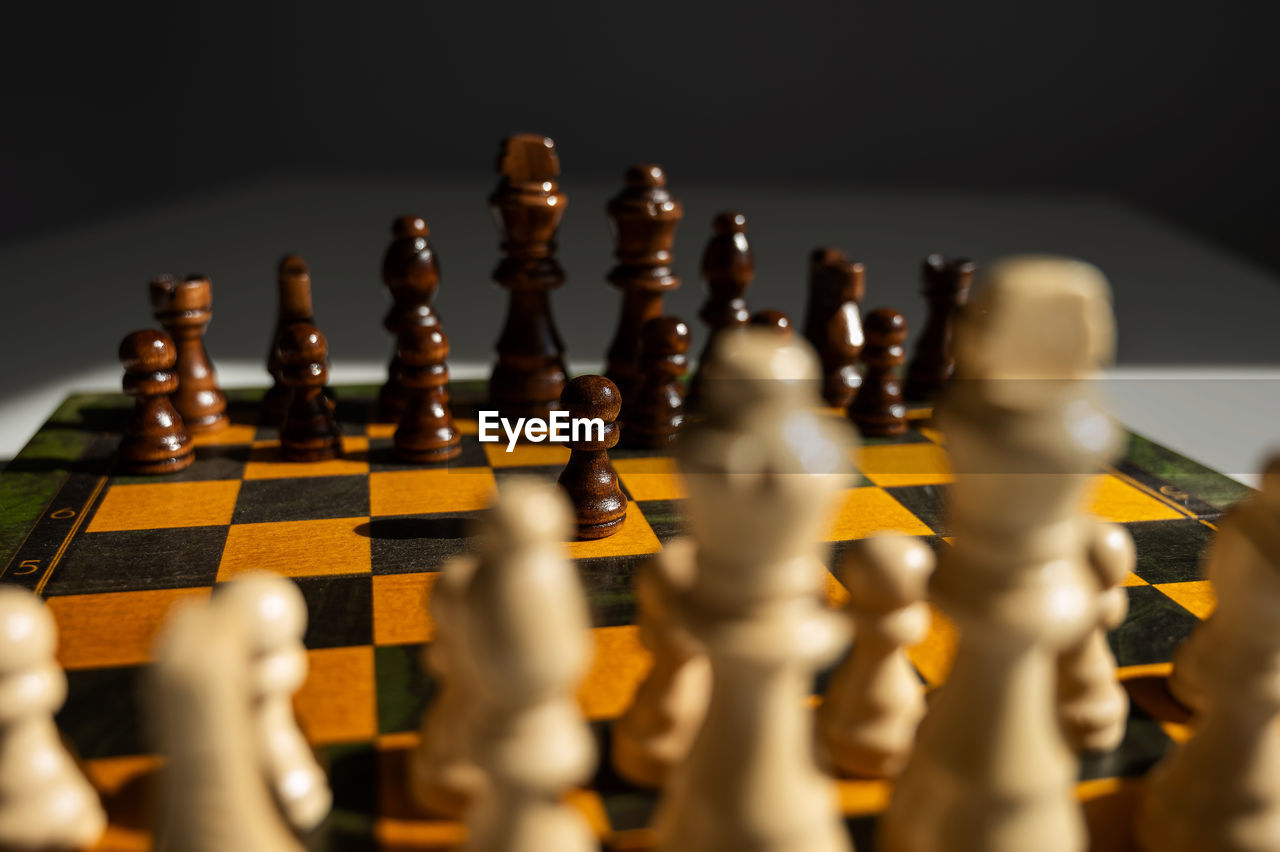close-up of chess pieces against black background