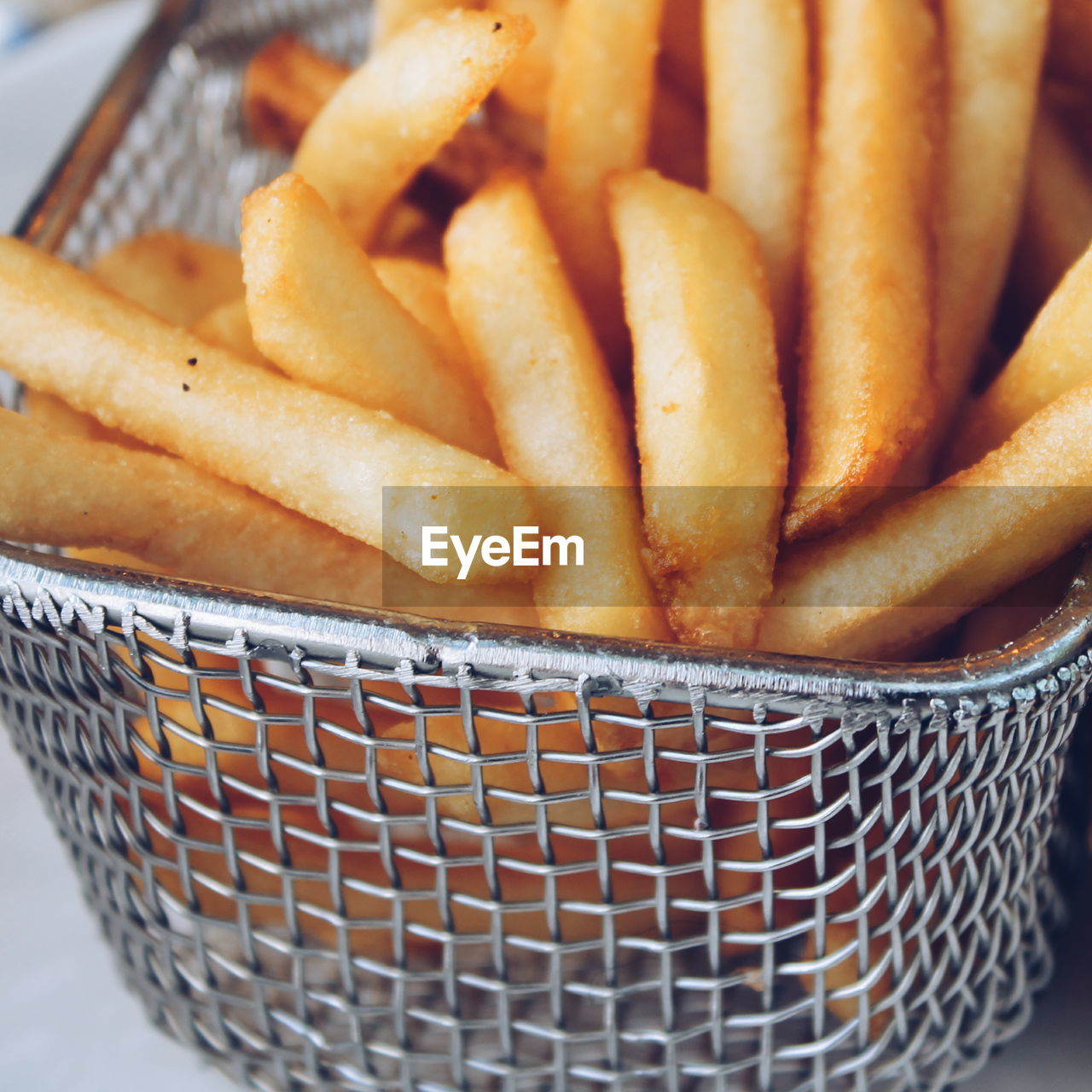 Close-up of french fries in metal container