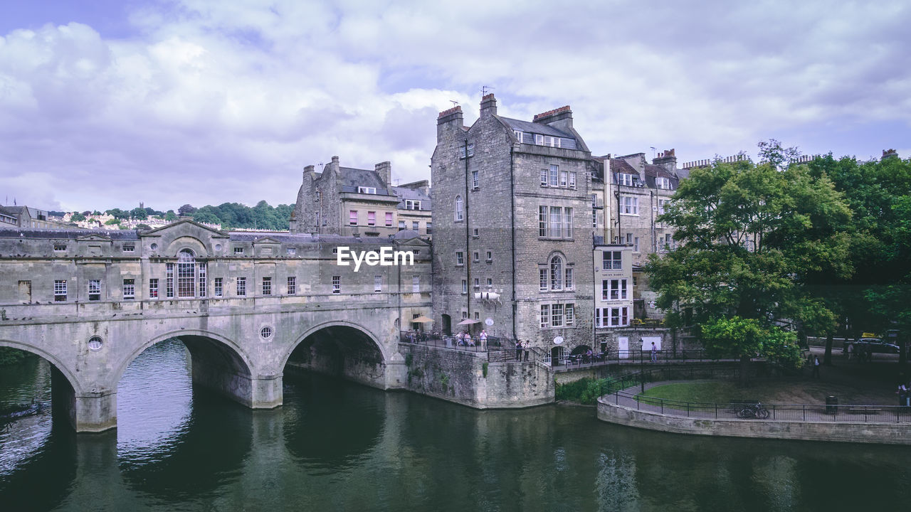 ARCH BRIDGE OVER RIVER AGAINST BUILDING