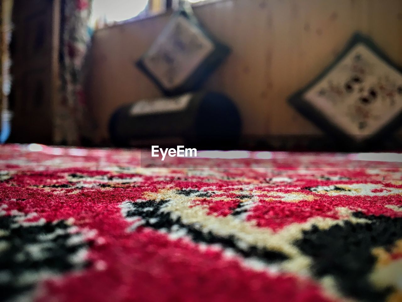 CLOSE-UP OF RED AND TABLE ON THE FLOOR