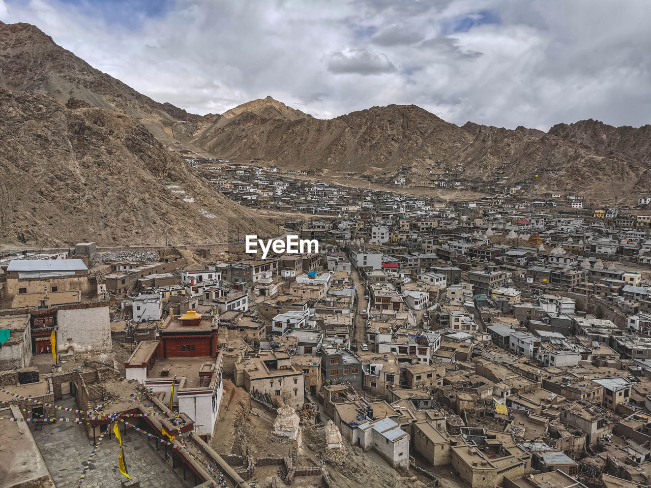 High angle view of townscape and mountains against sky