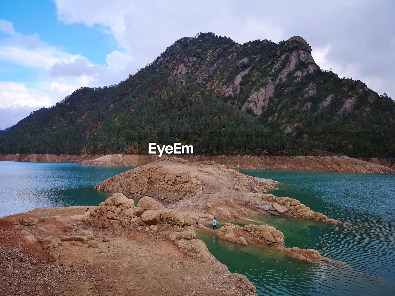 Scenic view of lake and mountains against sky