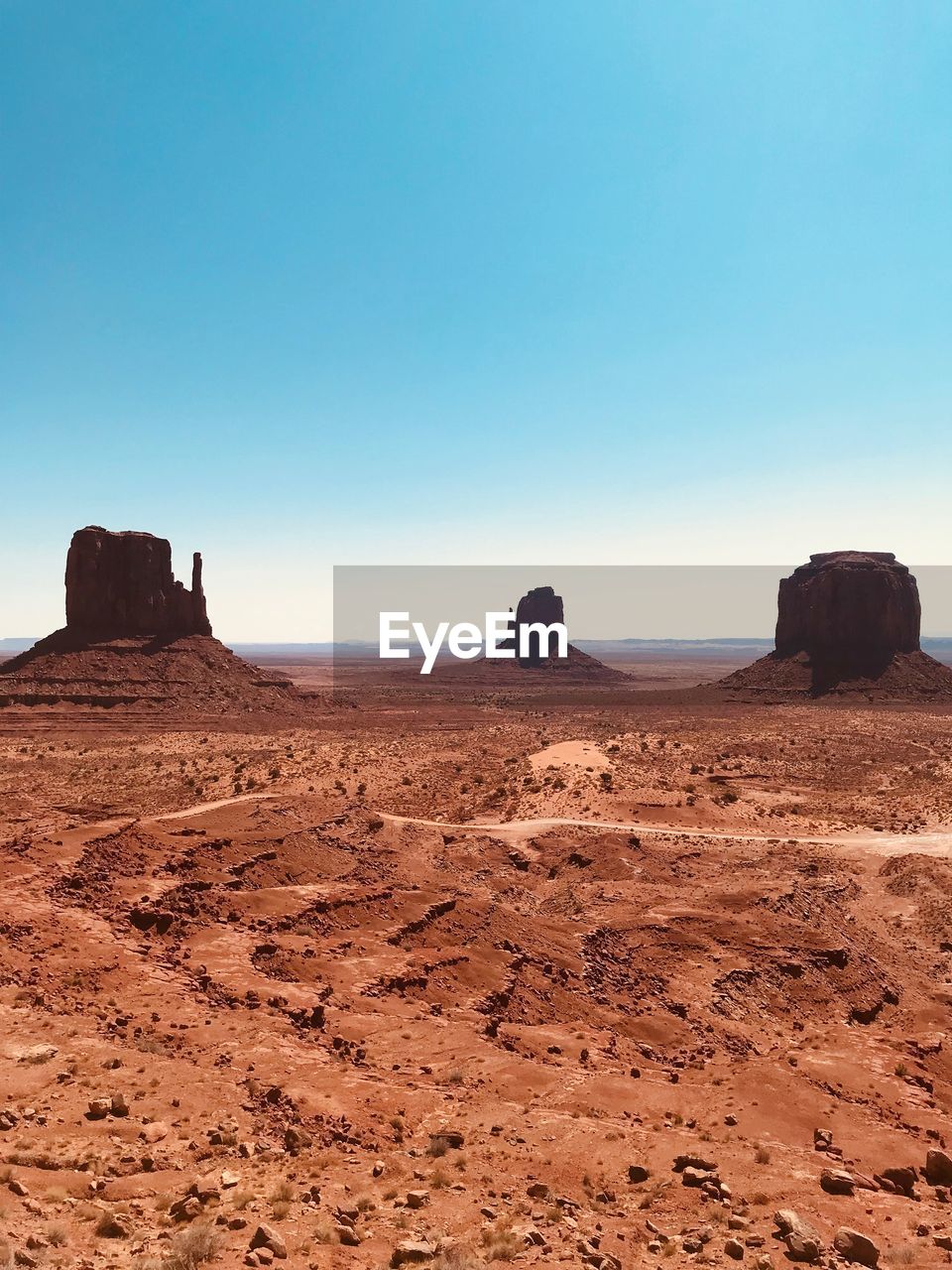 Scenic view of rock formations against clear blue sky